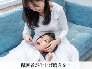 母親が仕上げ磨きをする様子